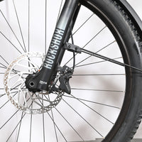 Gros plan sur la roue avant et la fourche RockShox du vélo électrique Loop Sports Cube Stereo Hybrid 120 Pro