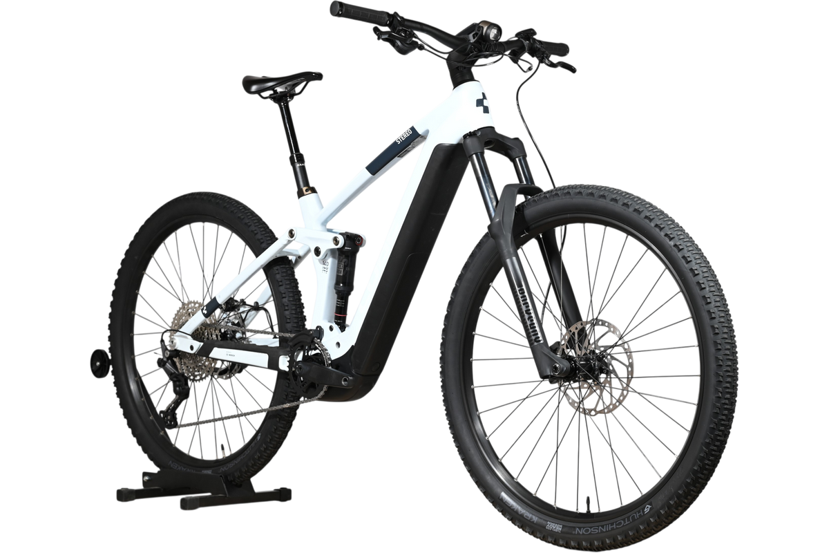 VTT électrique Loop Sports Cube Stereo Hybrid 140 HPC Pro 750 blanc et noir sur support en bois