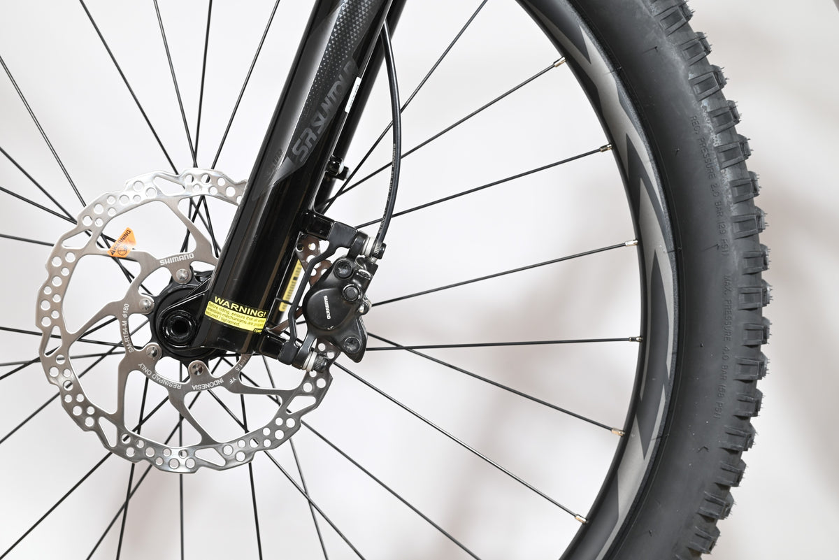 Gros plan sur le frein à disque hydraulique Shimano et la fourche SR Suntour du vélo électrique Loop Sports Giant Liv