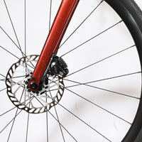 Gros plan sur le frein à disque hydraulique et la fourche rouge du vélo de route Giant Defy Advanced 2 Loop Sports