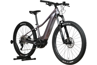 Velo electrique Loop Sports Giant Liv Vall E+2 2025 violet avec pneus tout-terrain Maxxis sur support en bois