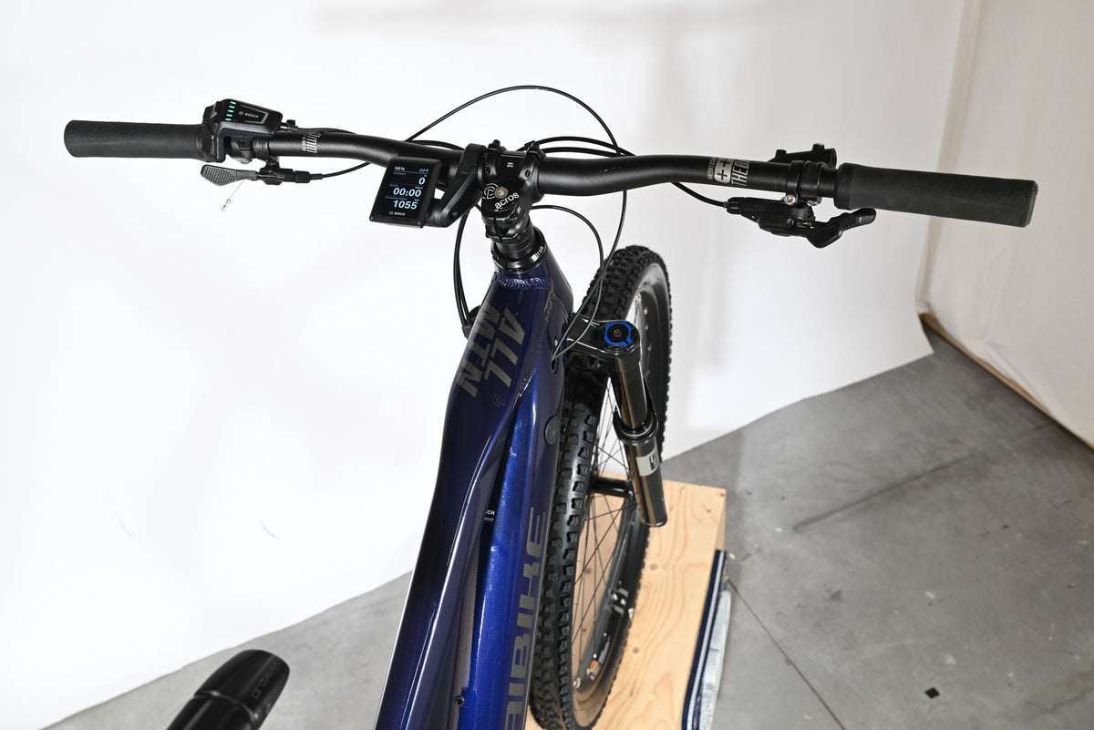 Vue plongeante du guidon et cadre bleu du vélo électrique Haibike Allmtn 6 chez Loop Sports avec écran Bosch