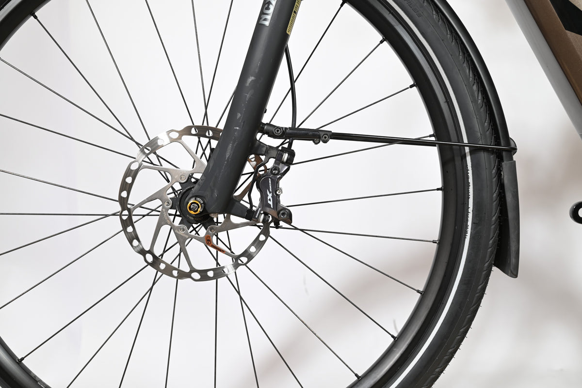 Gros plan sur la roue avant et le frein à disque hydraulique du vélo électrique KTM Macina Style 710 de Loop Sports