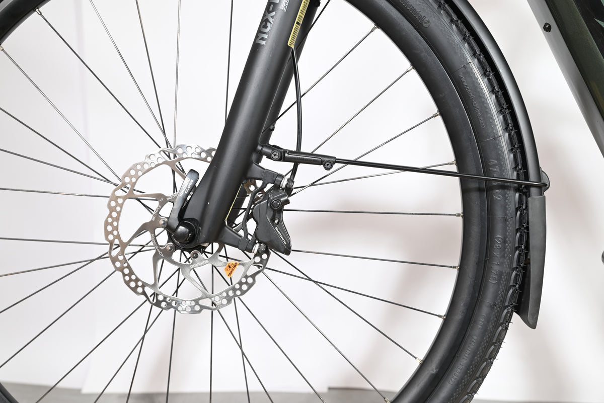 Gros plan sur la roue avant et le frein à disque hydraulique du vélo électrique Loop Sports KTM Macina Style 720