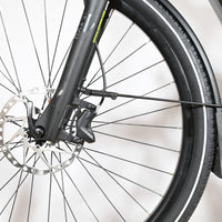Gros plan sur la roue avant et le frein à disque hydraulique Tektro du vélo électrique Loop Sports KTM Macina Style XL