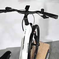 Vue rapprochée du guidon et du cadre blanc du vélo électrique Loop Sports Pegasus Premio Evo 11 40 Years