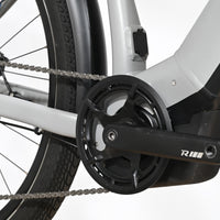 Gros plan sur le pédalier et le moteur électrique d'un vélo Raymon Tourray E 5.0 gris de Loop Sports