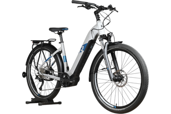 Vélo électrique Loop Sports Raymon Tourray E 5.0 blanc et bleu avec cadre ouvert et porte-bagages arrière
