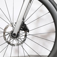 Gros plan sur la roue avant et le frein à disque hydraulique du vélo de route Loop Sports Scott Addict RC Team 2026