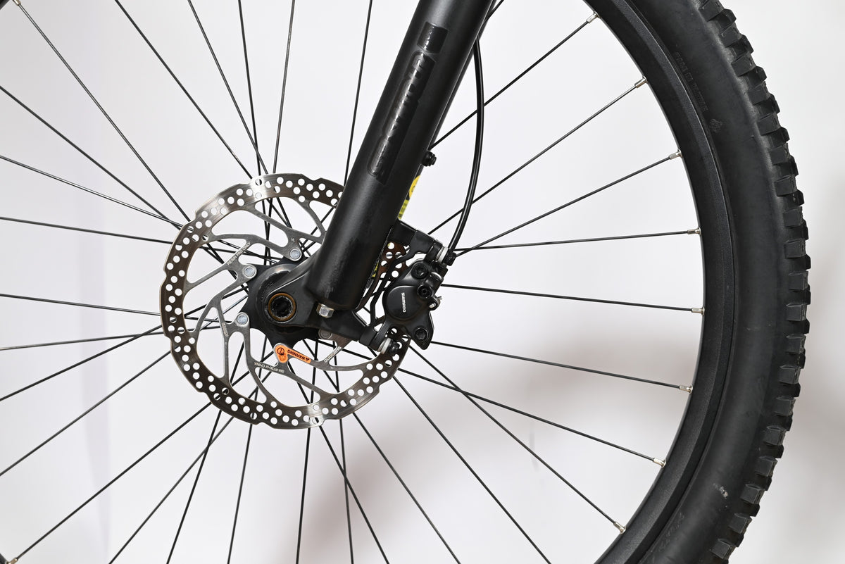 Gros plan sur le frein à disque hydraulique et la fourche noire du vélo électrique Sunn Rage S1 chez Loop Sports
