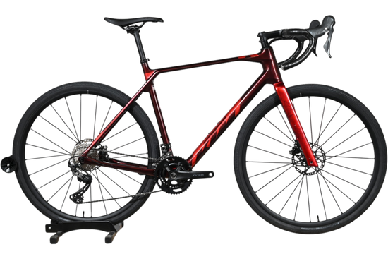 Vélo de gravel KTM X-Strada Elite 2024 rouge dégradé avec cadre en carbone, présenté par Loop Sports
